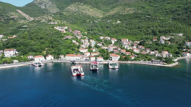 A drone flies over the village of Kamenari in Montenegro, where a passenger ferry sailing across the Bay of Kotor is arriving