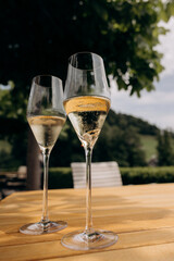 gold engagement ring with diamond lying in champagne and covered with bubbles on a black...