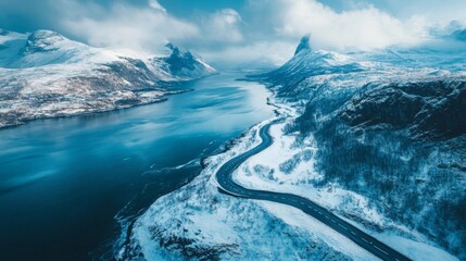 Aerial View of Snowy Mountains Landscape Along Blue Fjord During Winter Season