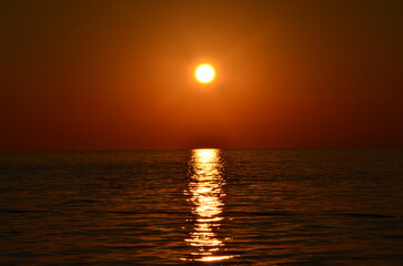 Golden sunset over calm sea