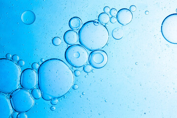 Close-up blue science experiment bubble texture,Bubbles in clear liquid, water or gel texture, oil drop, beauty collagen serum, hyaluronic essence skin care smear, aqua purity, abstract background.
