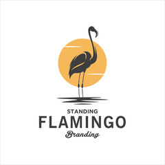 Silhouette Standing Flamingo Bird In A Pool Of Water With Sunset In The Background Logo Design