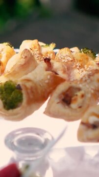 Sweet croissants with filling and strawberries at a festive dessert buffet. Banquet table at the event and holiday. Confectionery sweets close-up