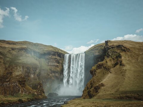 Skógafoss Waterfall, Iceland. Majestic cascade surrounded by rugged cliffs. - Powered by Adobe