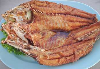 fried fish on blue plate