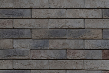 Textured brick wall with unique patterns and colors in urban setting