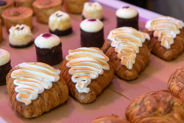 A variety of pastries and desserts are beautifully arranged on a display table