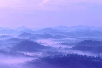 Fototapeta premium Misty mountain range at dawn, purple-toned vista