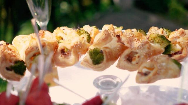 Sweet croissants with filling and strawberries at a festive dessert buffet. Banquet table at the event and holiday. Confectionery sweets close-up