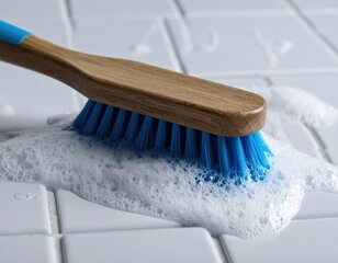 Blue bristle brush scrubbing soapy white tiles for deep cleaning routine