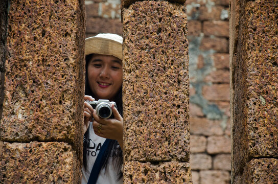 Travelers thai woman walking visit and travel take photo in ancient building and ruins of Kamphaeng Phet Historical Park