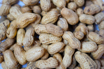Close-up of raw peanuts in shell, natural texture perfect for organic food backgrounds, farming themes, or healthy snack concepts.