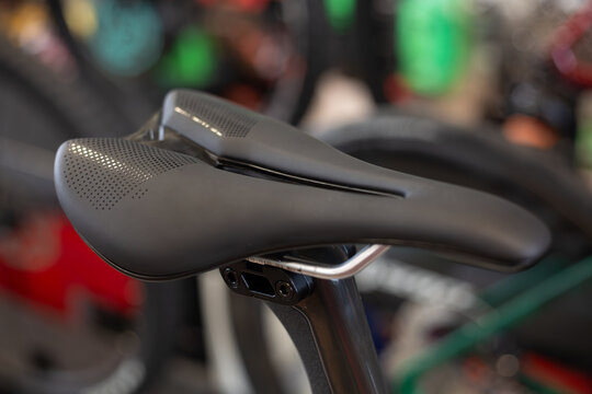 Detail of the sport saddle for bicycle. Elegant black and white racing saddle on the seat post, close-up.Racing bike.