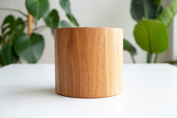 Cylindrical Wooden Container on White Surface with Blurred Greenery Background