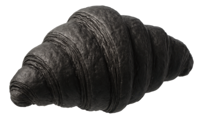 Charcoal-infused croissant showcasing a deep black color with a flaky and layered texture.