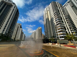 Fountain in the middle of a modern residential area. Multi-storey apartment buildings, Israeli city. Comfortable housing