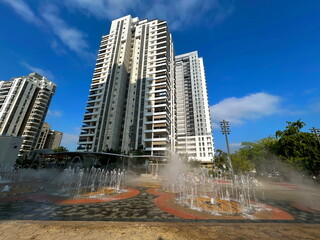 Fountain in the middle of a modern residential area. Multi-storey apartment buildings, Israeli city. Comfortable housing
