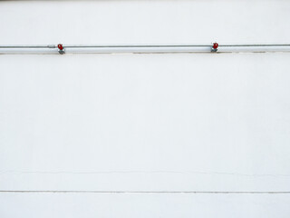 Steel Conduit Pipes on White Factory Wall.