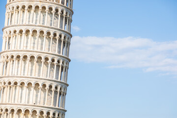 Pisa, Italy - Famous Leaning Tower landmark with blue sky, Renaissance white marble
