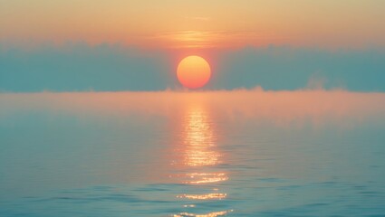 Beautiful misty morning sunrise over a tranquil sea. Gentle sky and distant wind turbines with bright sunlight reflecting on the water. Stunning calm and serene seascape symbolizing hope and peace