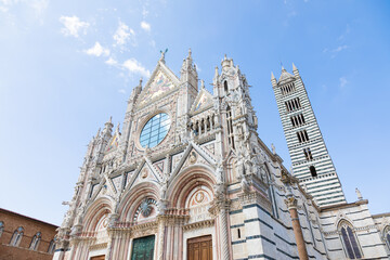 Siena cathedral in Italy. White marbles with blue sky, famous landmark of Tuscany.