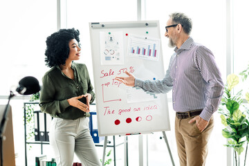 Professional business team discussing strategies and data analysis during a collaborative meeting in an executive office