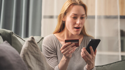 Woman holding credit card and mobile phone
