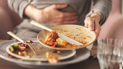 Woman with bloating and stomach pain after eating