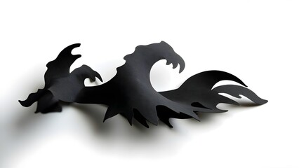 Fototapeta premium Artistic black paper cutout of a wave symbolizing power and movement on a white background