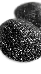 Two Sparkling Mountains of Black Glitter Powder Over White Background