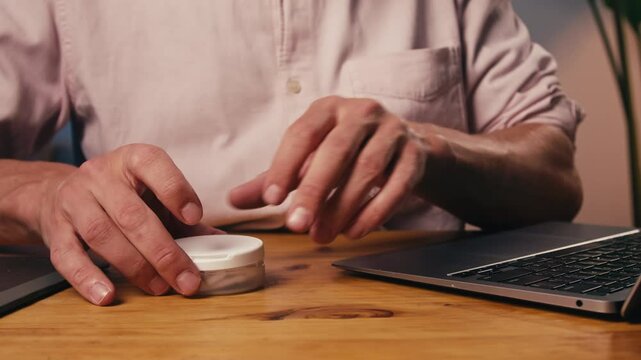 Snus nicotine tobacco close up, pack of tobacco for gum. unhealthy addiction. Man opening box with snus and taking one. 