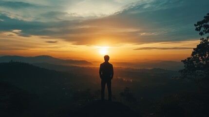 Silhouette of business male stand and feel happy on the most hight at the mountain on sunset, success, leader, teamwork, target, Aim, confident, achievement, goal, on plan, finish,