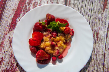 Delicious homemade strawberry bars with red topping at wooden table