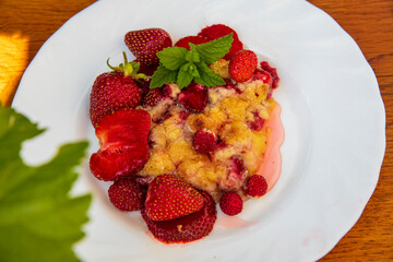 Delicious homemade strawberry bars with red topping at wooden table