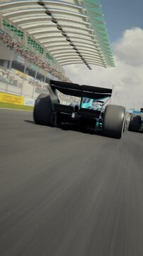 Dynamic high speed drone shot passing generic formula one race cars racing along the homestretch over the finish line. High quality 3d animation