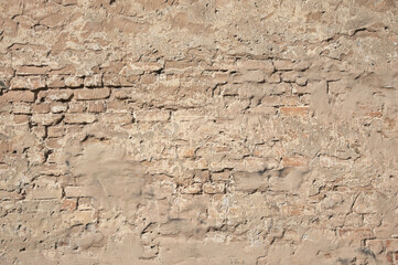 brown background, in the photo an old brick wall and old plaster