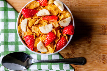 Bowl Of Classic Corn Flakes Breakfast Cereal With Fresh Strawberries And Banana