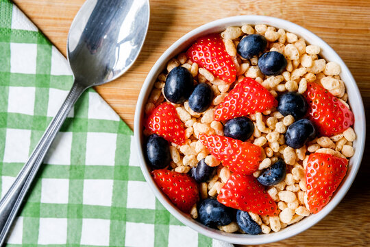Bowl Of Classic Rice Krispies Breakfast Cereals With Fresh Strawberries And Blueberries