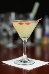 Elegant Martini Glass on Bar: A refreshing cocktail, perfectly chilled and garnished, awaits amidst the ambiance of a sophisticated bar setting.