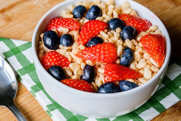 Bowl Of Classic Rice Krispies Breakfast Cereals With Fresh Strawberries And Blueberries