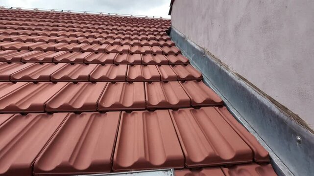 Panoramic view of the newly constructed roof with a dormer window on a historic house. New roof covering with roof tiles. Concept of house history and construction