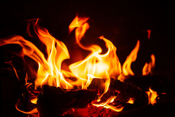 Flickering flames dance against a dark backdrop, creating a mesmerizing display of warmth