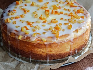 classic cheesecake made of ground cottage cheese, decorated with icing and candied orange peel