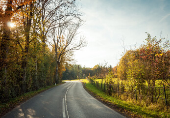 Road through autumn countryside. Winding road in rural area between villages in Styria. 
