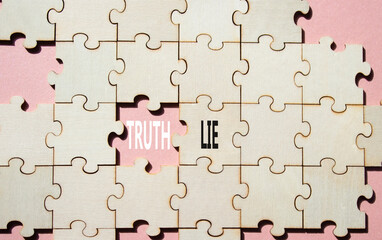 Truth or Lie symbol. Concept word Truth or Lie on wooden puzzle. Beautiful pink background....