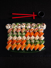 Colorful sushi rolls and sashimi artfully arranged, inviting a delightful tasting experience