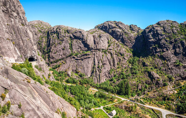 Scenic Mountain Landscape with Steep Cliffs and Lush Greenery Under Blue Sky, Jossingfjord, Norway, 14 July 2018
