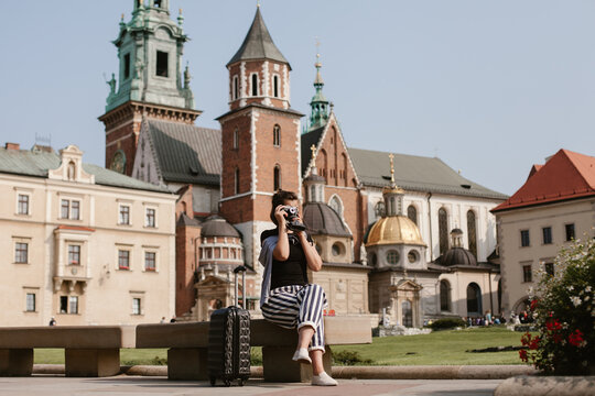 Tourist taking photos of wawel castle in krakow, poland