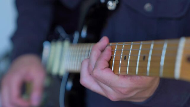 Mastering guitar techniques in a cozy room for aspiring musicians