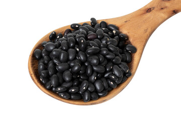 Close-up of black beans on wooden spoon cut out